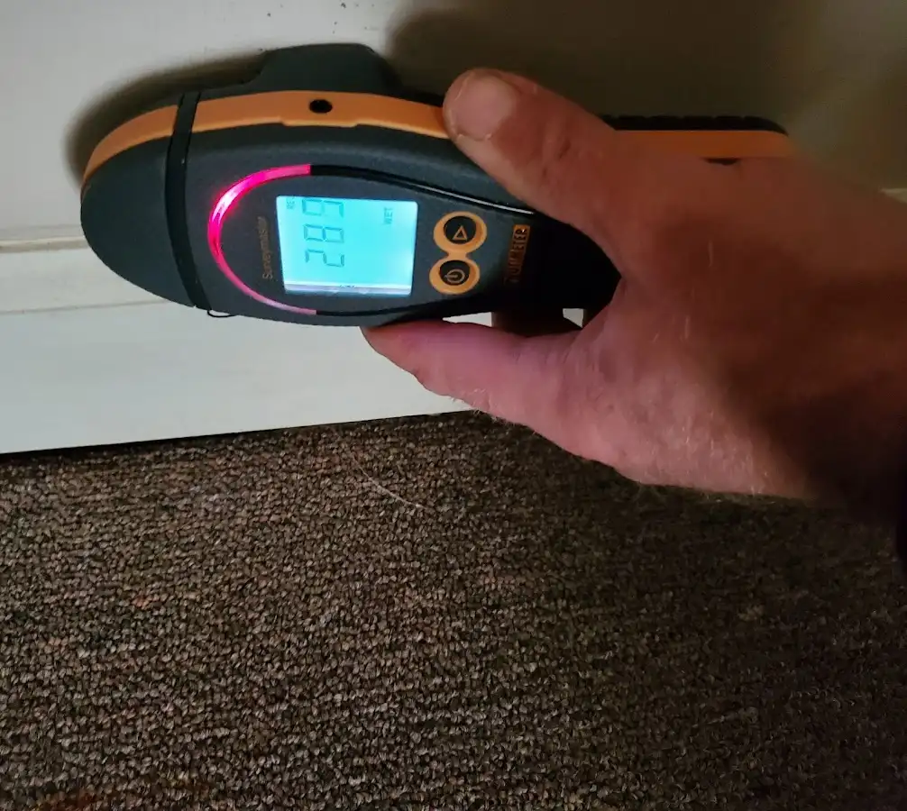 Moisture detection at baseboard during Storm Damage Restoration in Clayton